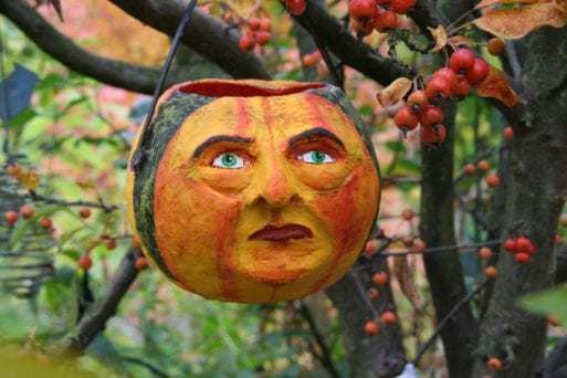 carved pumpkin in a tree 