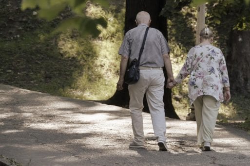 an elderly couple hold hands before the murder-suicide