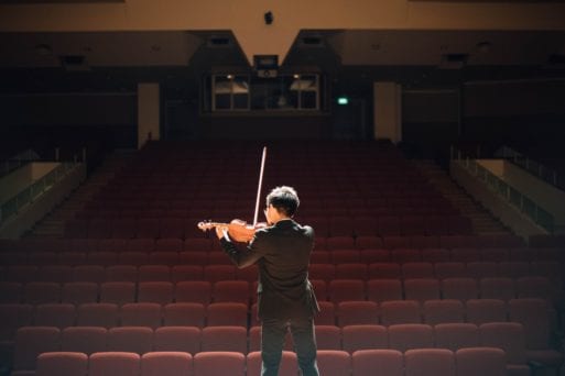 image of a man playing violin as an example of live music concerts online 