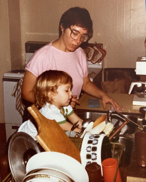 I’m a toddler washing dishes with my mother before my mother died