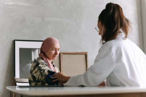 A doctor takes the blood pressure of a cancer patient unable to receive transfusions in hospice.