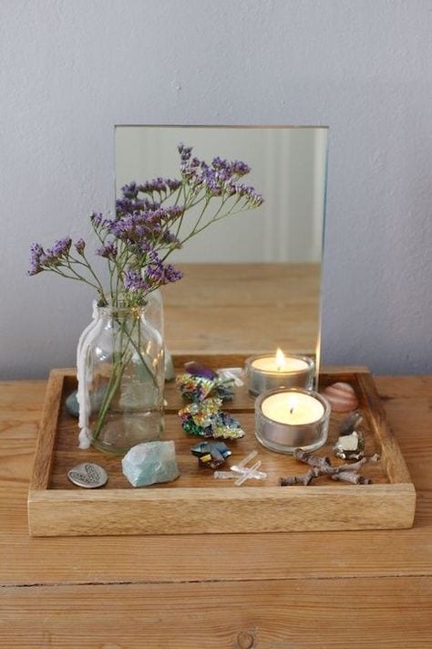 A simple grief shrine set up on a dresser with dried lavender and candles