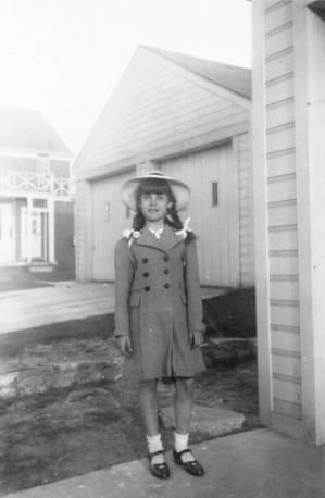 Susanna standing in front of her girlhood home