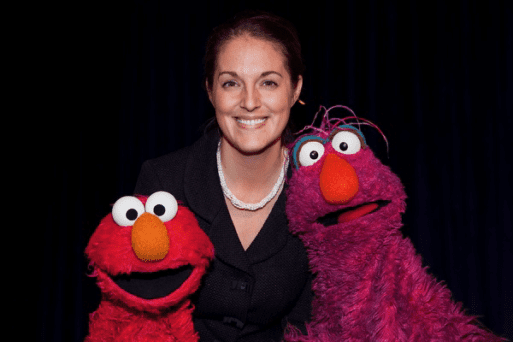 Joyal Mulheron, founder of Evermore, a nonprofit advancing bereavement care, poses with Elmo & Telly.