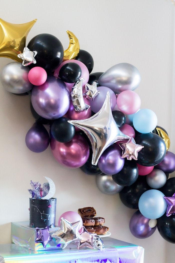 Celestial-themed pearlescent balloon decorations for a celestial remembrance event