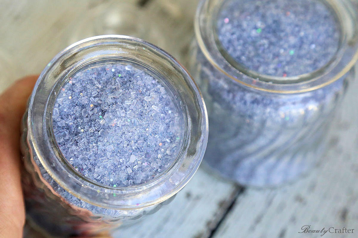 Two jars of lavender-colored edible glitter, which can be used to decorate refreshments at a celestial remembrance event