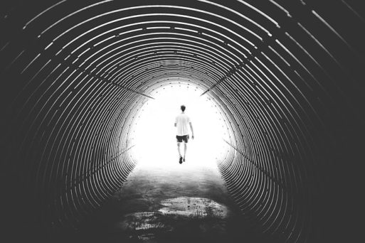 Man running through a tunnel, representing a near-death experience