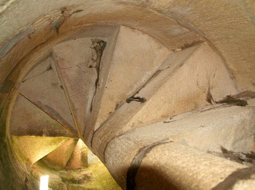 A stone spiral staircase inside the Lantern of the Dead in Fenioux.
