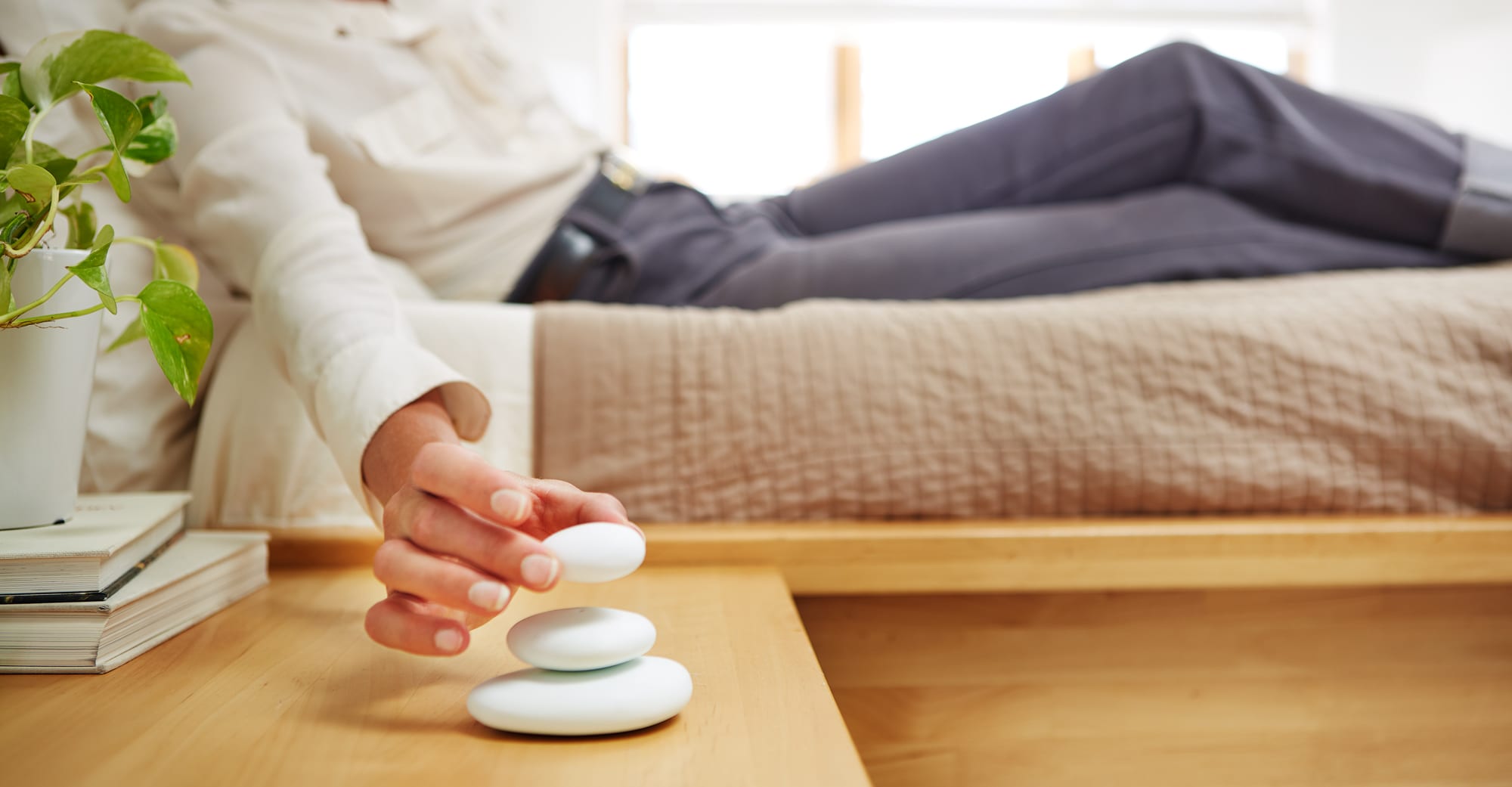 A woman stacks Parting Stones on a table.