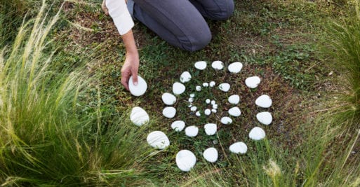 White Parting Stones are placed in a spiral in the grass