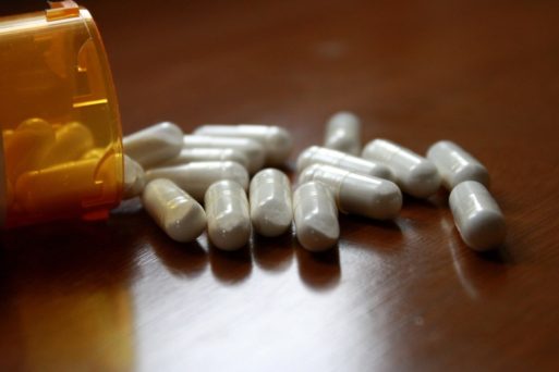 Bottle of prescription pills spilled on table - decreased life expectancy among young Americans