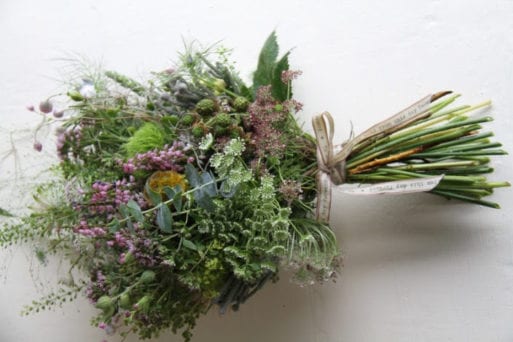 A wildflower casket spray tied with a ribbon