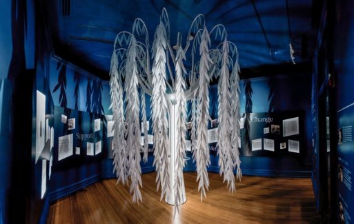 Photograph of white willow tree sculpture in museum - part of exhibit on child loss