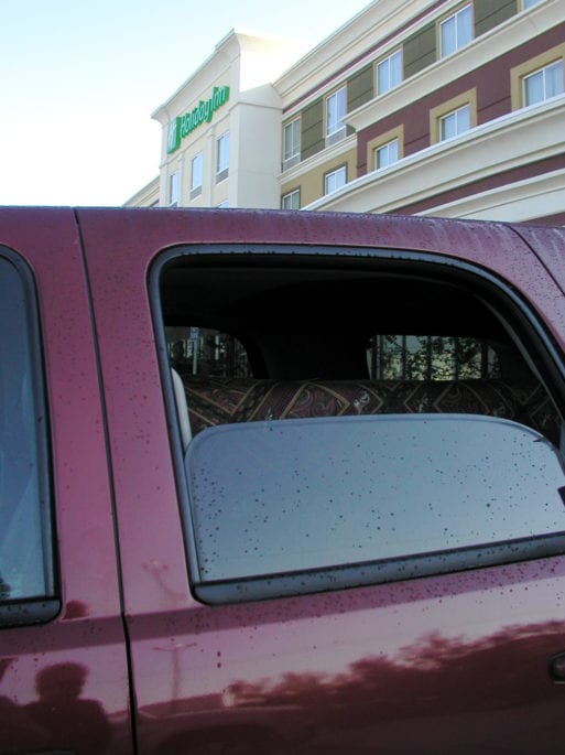 A view through the red Chevrolet Tahoe's window doesn't reveal that it's being used for body transport.