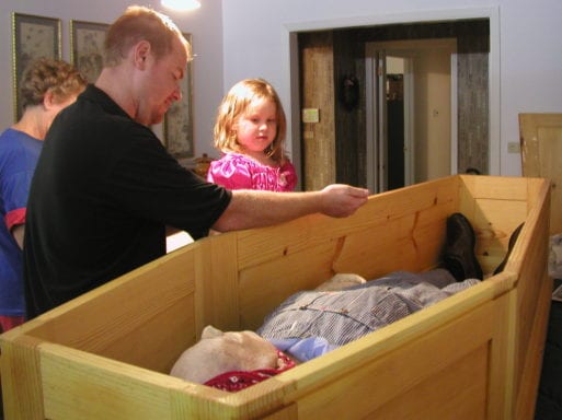 Bates' family members view his father's body within the home prior to transport.