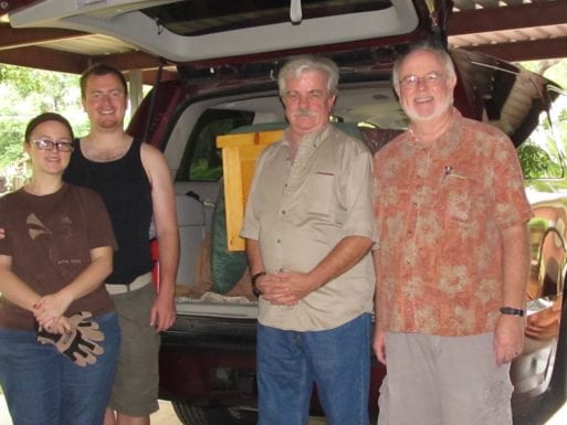 Jim Bate and his family, preparing to transport his father's body by vehicle, pose outside the Chevrolet Tahoe.