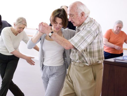 A man with Parkinson's Disease dances with Olie Westheimer of Dance for PD