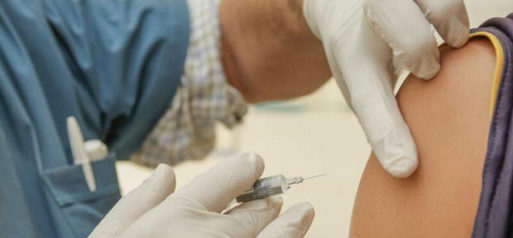 Close-up photograph of shot being administered - vaccine boosters