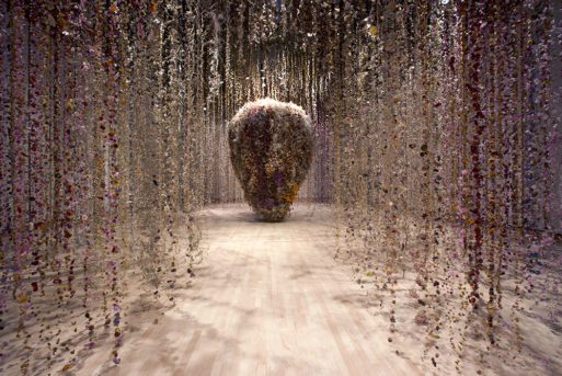 A womb pictured amid strings of hanging flowers in this installation.