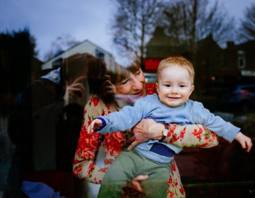 thankful grandmother holding cute baby