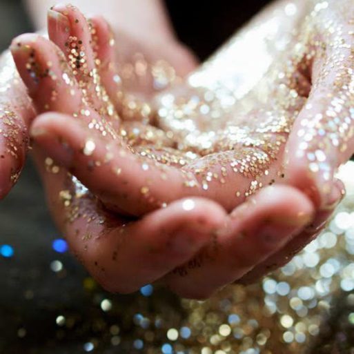 A women's hands covered in sparkles