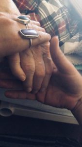 image of hands holding each other symbolizing support from death care workers at end of life