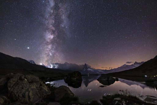 A winter mountainscape gives way to the heavens.