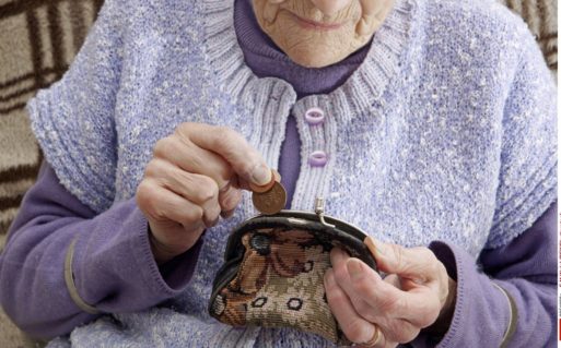 Elderly woman counting pennies can't afford Medicare rate hike