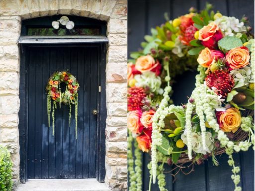 A colorful memorial wreath hangs on a wooden door.