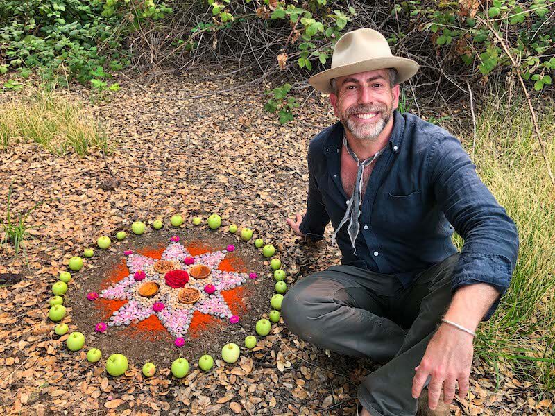 Day Schildkret poses with one of his morning altars as a demonstrations of rituals