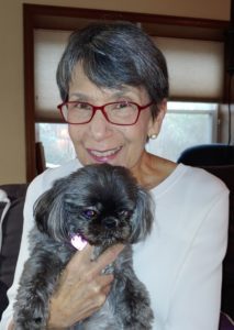 Psychologist Marilyn Mendoza poses with her pet dog.