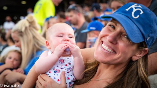 Burns, whose work supports bereaved children, poses with a young baby and smiles.