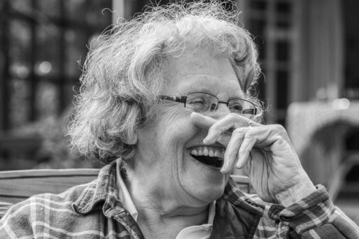 an older woman with glasses laughing