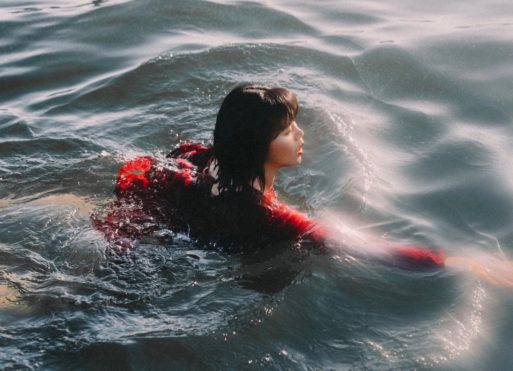 A woman in red wades shoulder-deep through the water like the narrator in Barbara Crooker's poem