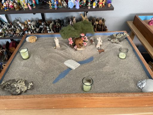 A tree, animals and candles that Yockey placed during sandplay.