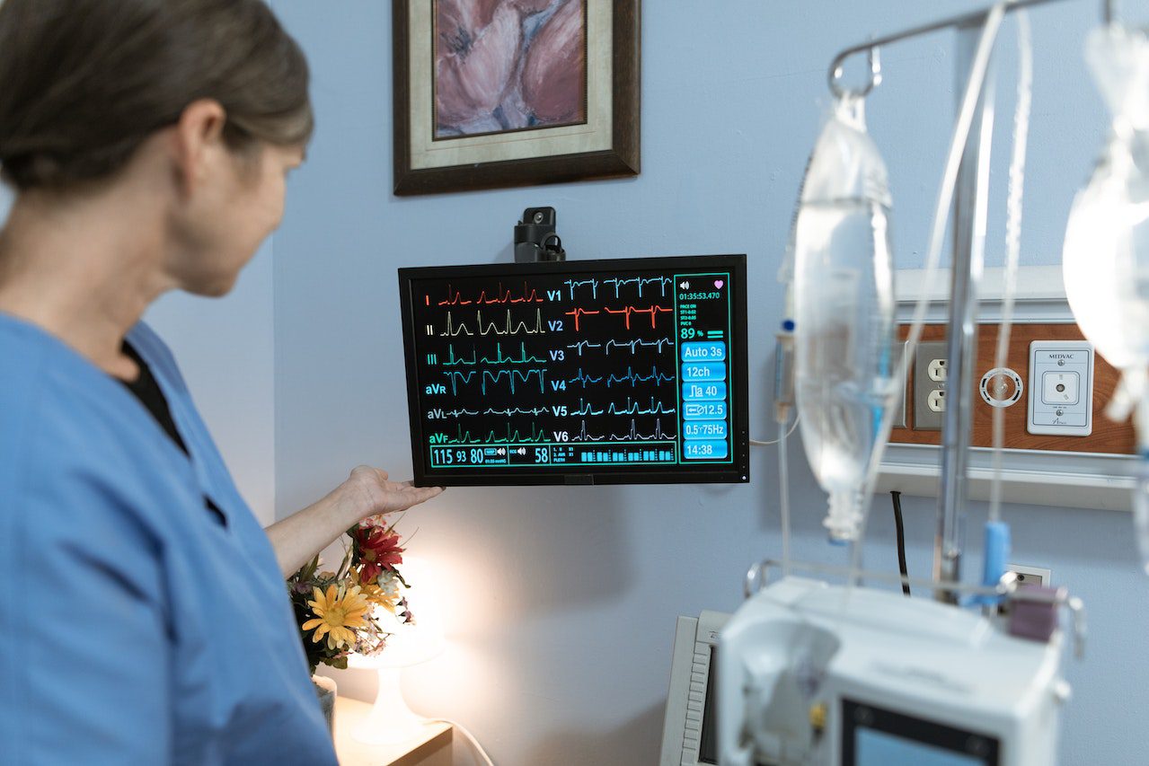 an icu nurse monitors person with heart problems after intense grief