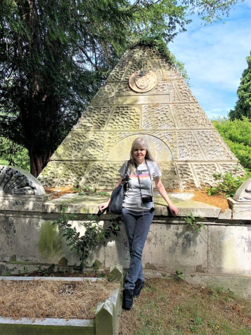 headstone hunter Jeane Trend-Hill standing by monument