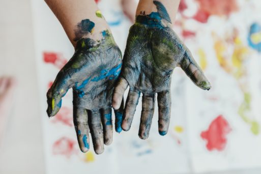 A child's hands smeared with finger paint