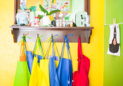 colorful aprons on pegs used in fingerpainting