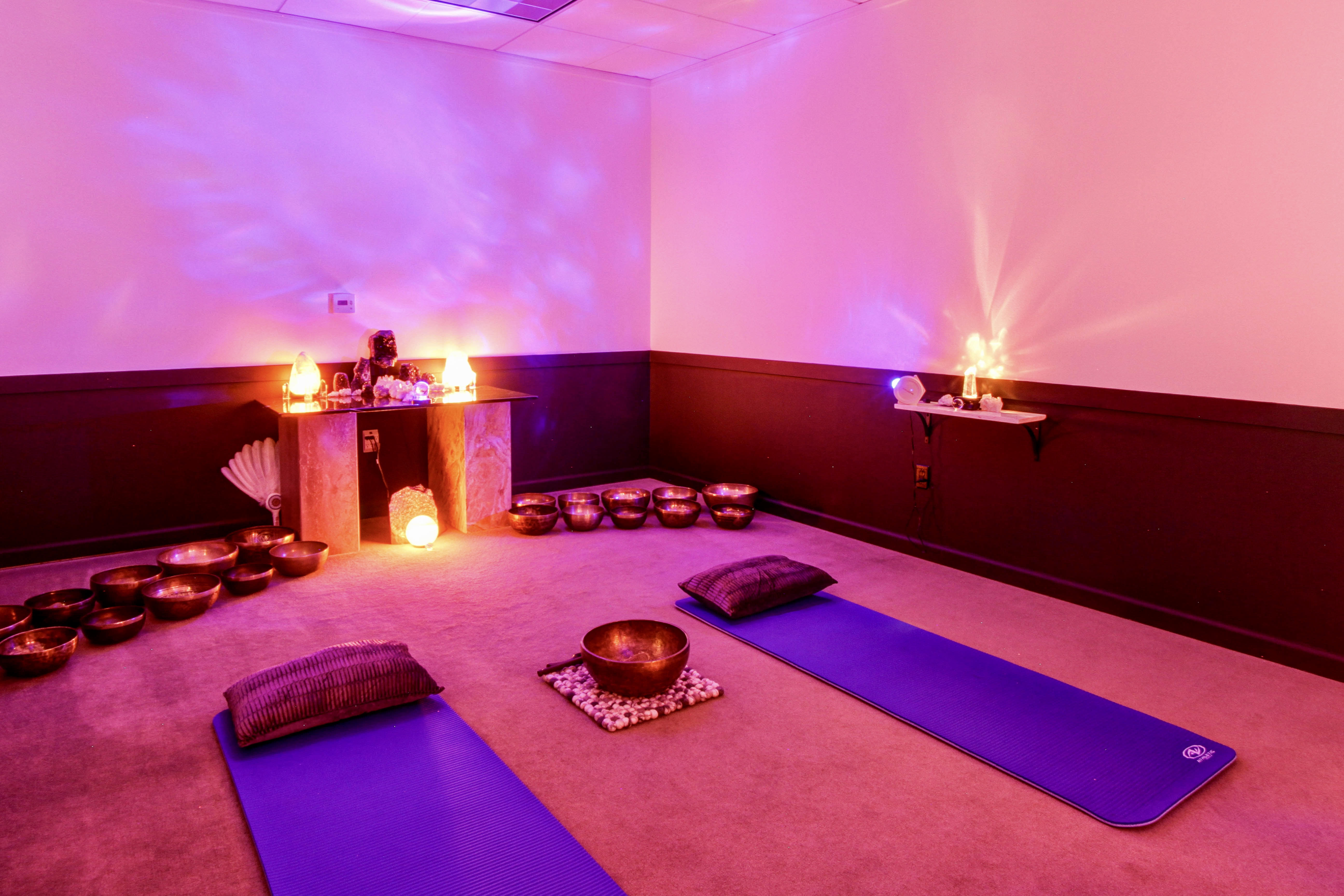 Stark's studio set up with crystals, yoga mats, and singing bowls.
