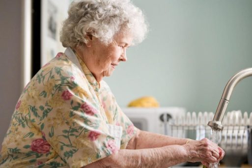 Elderly woman washes her hands to avoid dying from COVID-19