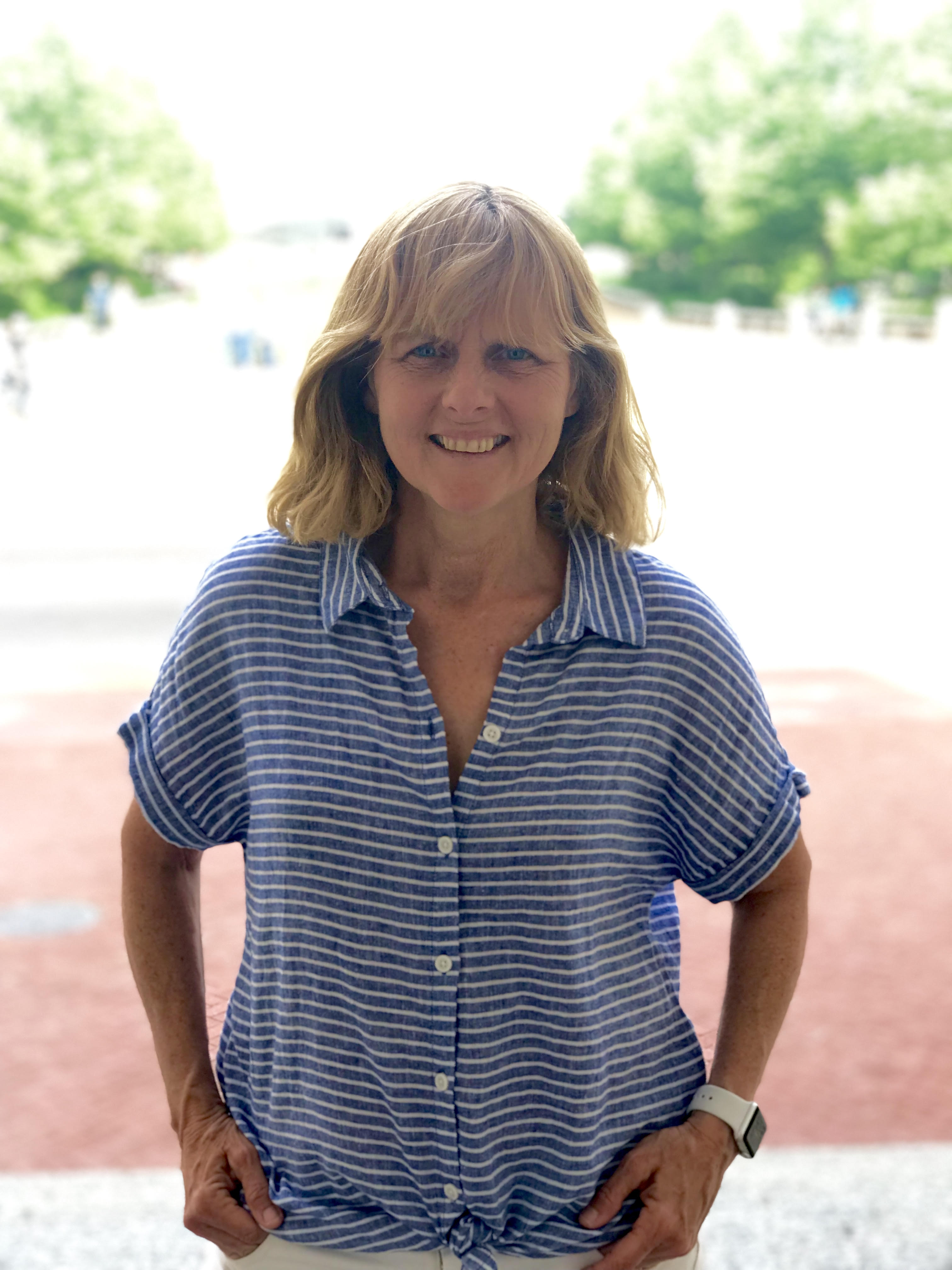 Lisa Athan, a grief recovery specialist who's delivered news that someone has died to individuals and families, poses outdoors.