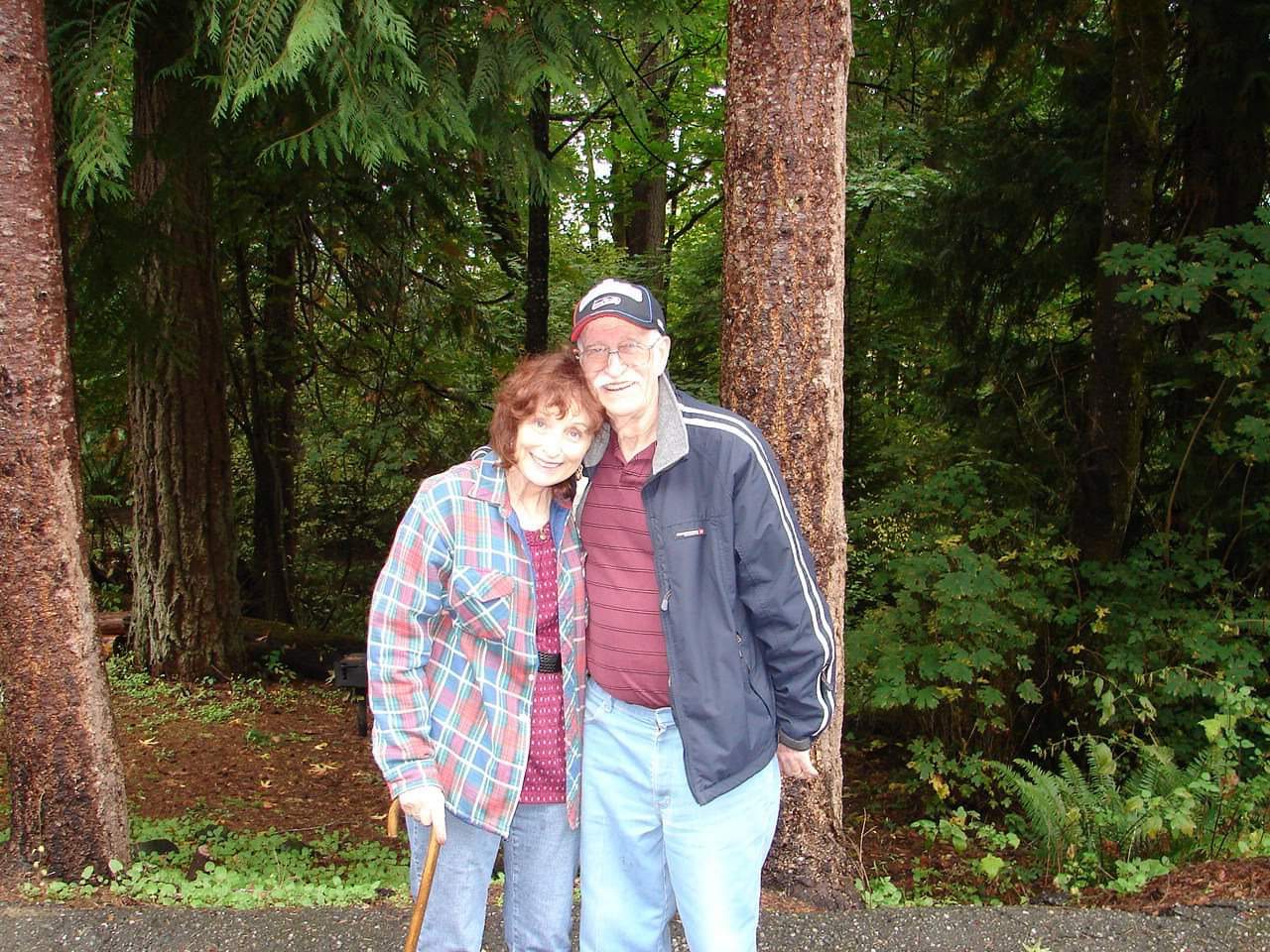 Wayne and Valerie McDonald pose in a forest 