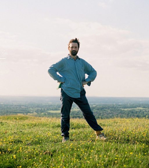 Tom Rosenthal standing in a field