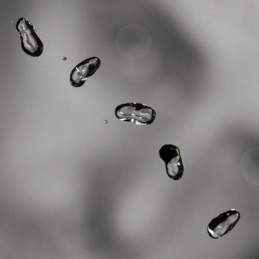 Droplets fly through the air on the album cover on which "I Grieve" appears.