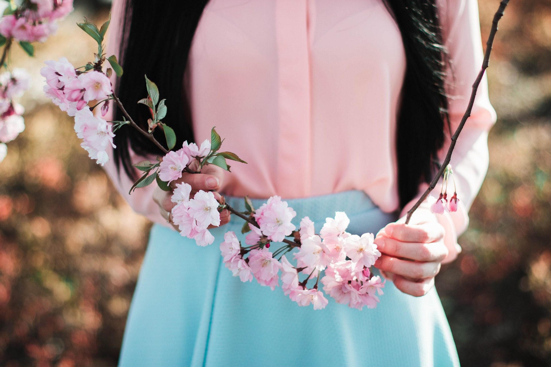 woman holding a flower spray