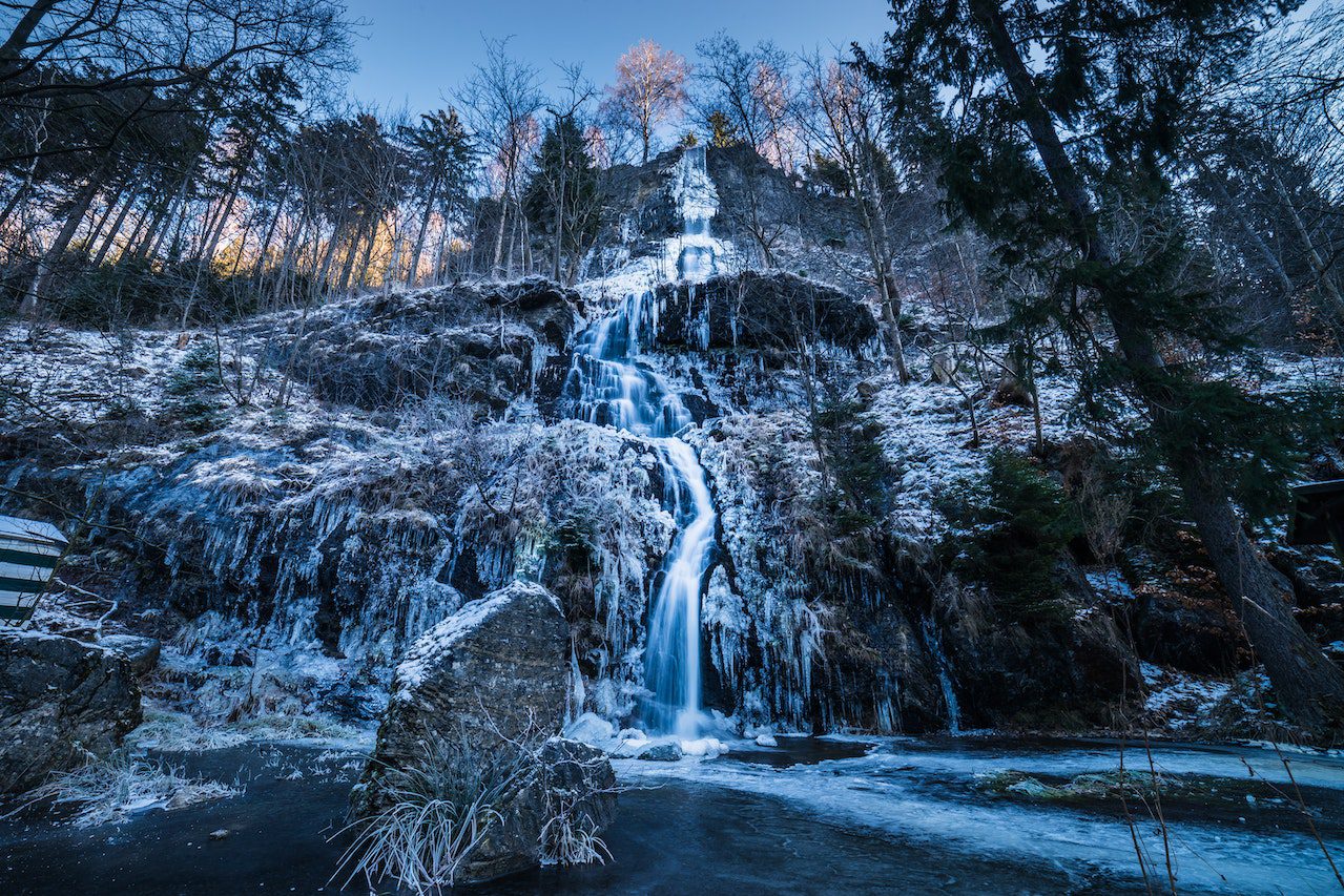 A picture of a waterfall on a fertile earth.