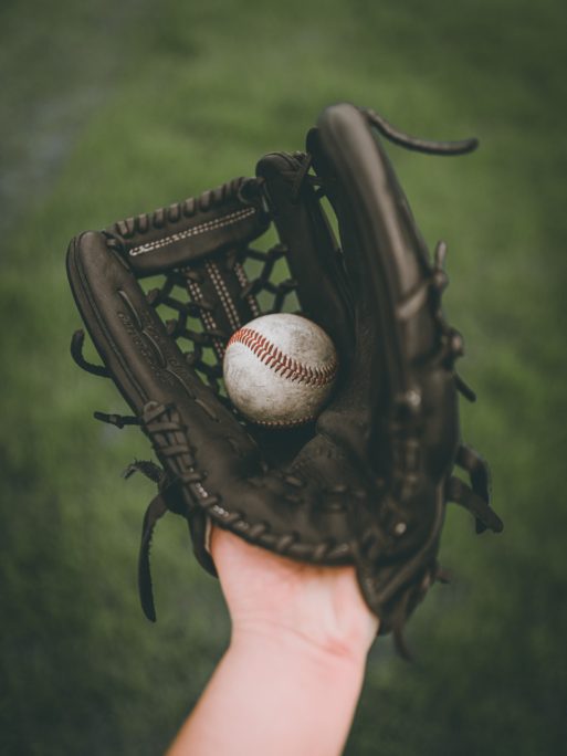a baseball glove with a ball like the one Allie would've used in the catcher in the rye