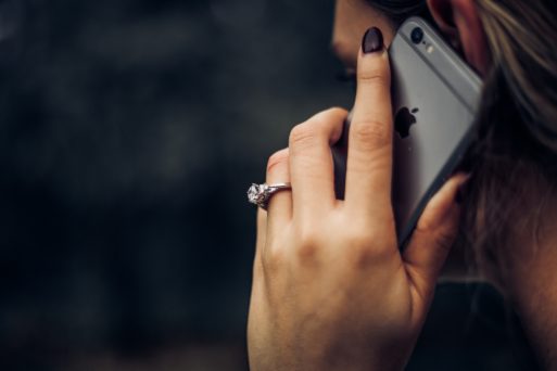 woman on phone with funeral scam