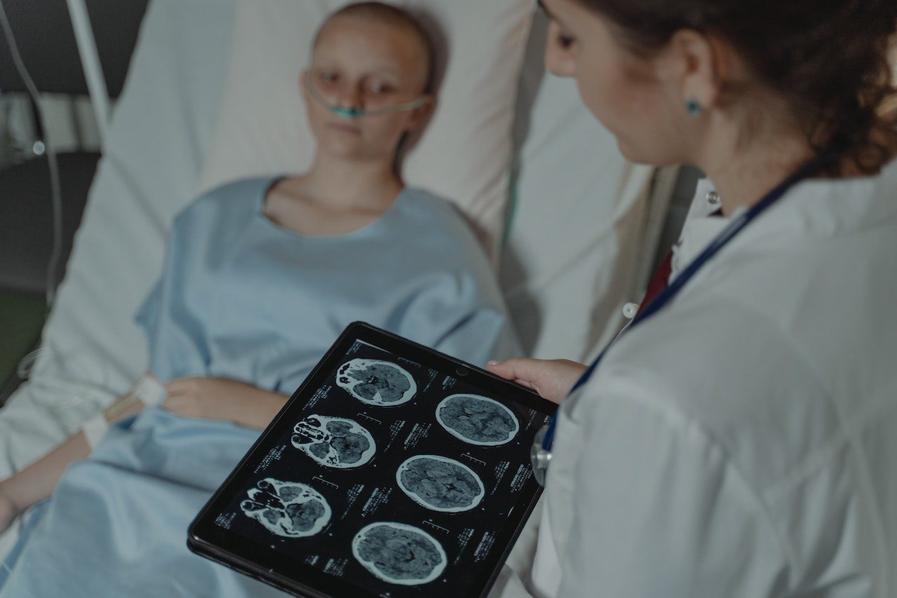 A doctor looks at a patient's scans to determine brain activity.